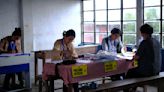 AP PHOTOS: For the world's largest democratic exercise, one village's polling officers are all women