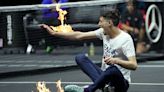 Protester sets arm on fire on court ahead of Roger Federer's farewell tennis match at Laver Cup