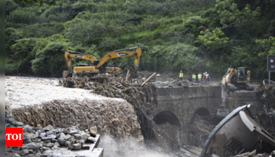 Rescuers search for dozens missing after flooding and a bridge collapse in China kill at least 25 - Times of India