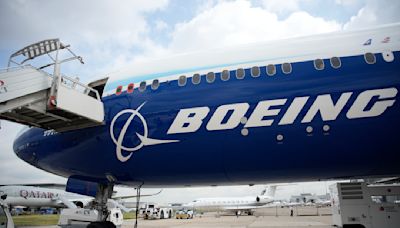 Boeing names its next CEO while posting a quarterly loss of more than $1.4 billion