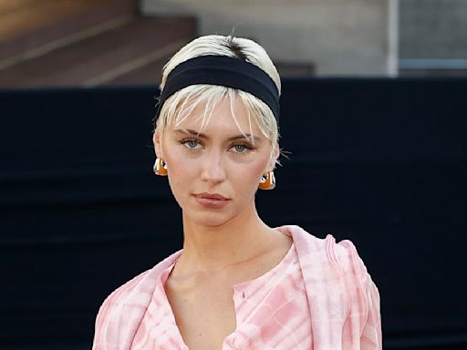 Iris Law wears a pink checked blouse at Burberry's LFW show