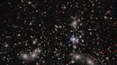 Scientists used a galaxy cluster that warps space-time as a giant magnifying glass to find 2 distant galaxies