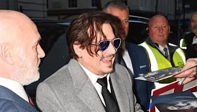 Johnny Depp flashes yellowing smile at fans at first UK premiere since Amber Heard trial