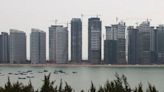 Fighting slowdown, China imposes pay limits on bankers