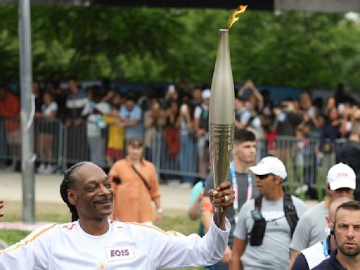 Snoop Dogg lights up Games as he carries the Olympic torch before opening ceremony in Paris