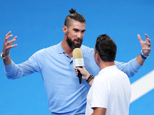 5 photos of Michael Phelps and his delightful man bun enjoying the 2024 Paris Olympics
