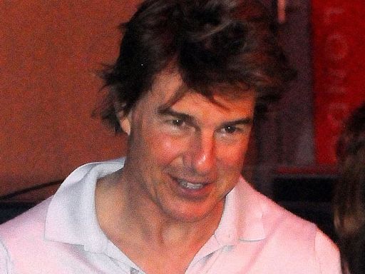 Tom Cruise, 62, gives a thumbs up as he lands his helicopter in London