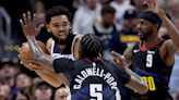 The Minnesota Timberwolves' Karl-Anthony Towns, top left, comes under pressure during the first quarter against the Denver Nuggets' Justin Holiday and Kentavious...