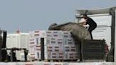 During a tour organised by the Israeli military on May 1, 2024, aid is unloaded in Beit Hanun, north Gaza, after its delivery from Jordan through the Israeli-controlled Erez crossing