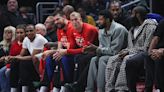 LA Clippers starters, including Paul George, James Harden and Kawhi Leonard, sit on the bench in street clothes during a game against the Houston Rockets...