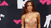 Anitta flashes her bum in fishnet cut-out shorts and a sparkly thong