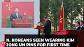 N. Koreans wear Kim Jong Un pins for first time as personality cult grows, AP explains