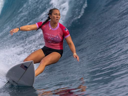 American Carissa Moore began defense of her Olympic surfing title, wins first heat