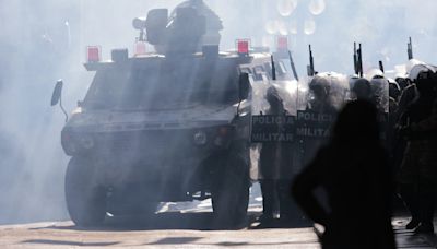 Troops and armored vehicles disperse as Bolivia arrests army chief leading coup attempt