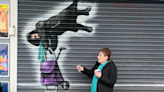 Viral video of grandmother caught in shop shutters immortalised in spray-painted mural