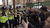 Several police officers injured in violent clashes between protesters across the UK