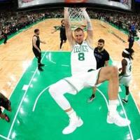 Boston's Kristaps Porzingis dunks in the first quarter of the Celtics' victory over Dallas in game one of the NBA Finals