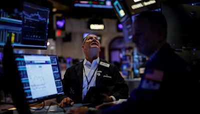 Dow registers record high close as US jobs data eases economic worries