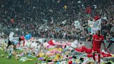 Fans of Turkish soccer club Beşiktaş J.K. toss stuffed toys onto pitch for children affected by earthquakes