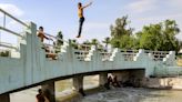 Iraqis flock to river or ice rink to escape searing heat