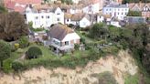 Woman refuses to leave £1m cliff-top despite being warned of collapse