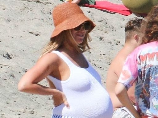 Heavily pregnant Ashley Tisdale shows off huge baby bump at beach