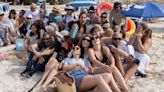 Majorcans cram together on beach towels in protest against tourists