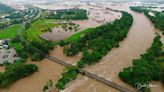 Families stranded on rooftops as heavy rains batter northern Australia and crocodiles stalk floodwaters