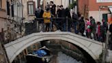 Pictures show grounded gondolas and miserable tourists in Venice as canals run dry due to drought and low tide