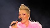 Pink vows to 'kick a**' as she returns to the stage following brief illness