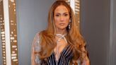 JLo's metallic gown features super high front split and matching underwear as she shows off sky-high heels