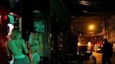 Funk dancers perform outside a bar during a music video shoot in the Heliopolis favela in Sao Paulo