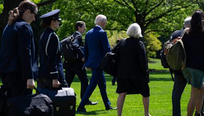 Pictured: Joe Biden ‘uses team of walkers to hide shuffling gait’