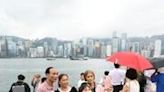 Tourists from mainland China visit the Tsim Sha Tsui waterfront in Hong Kong on May 1, the start of the 'Golden Week' holiday