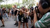 Spanish minister condemns mob who squirted diners with water pistols