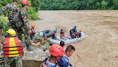 Two buses carrying more than 50 people swept into river by landslide in Nepal