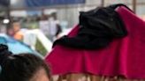 A migrants cries next to her tent at a shelter in Tijuana as she talks about her ordeal