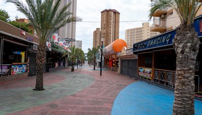 Inside abandoned Benidorm street with desolate nightclub & rotting golf course