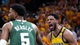 ...Haliburton of the Indiana Pacers reacts after a dunk while Milwaukee's Malik Beasley looks on during the Pacers' series-clinching victory over the Bucks in game six of their NBA...