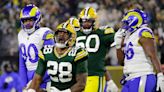 AJ Dillon rocks his Christmas jammies and Aaron Jones wears matching colors, adds a Santa hat to his sombrero as Packers arrive for game vs. the Dolphins