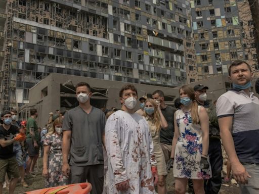 Mourning in Kyiv as rescuers clear rubble from children's hospital