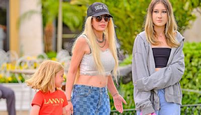 Tori Spelling shows off taut tummy as she steps out with her kids