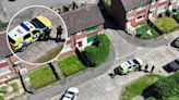 Armed police with guns drawn swarm estate after reports of 'group street brawl'