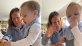 Toddler won't let grandma stand in way of relentless attempts to eat toy