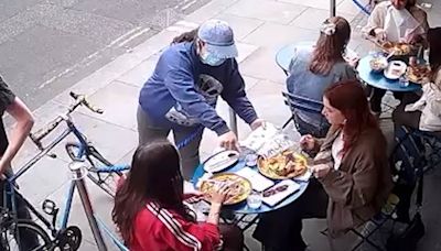 Moment woman's phone pinched by mask-wearing pickpocket