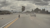 Dashcam shows car catapult into air after being hit by a detached tire on highway