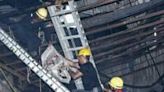 Rescue workers carry a victim after a fire broke out at an amusement park facility in Rajkot, in India's Gujarat state