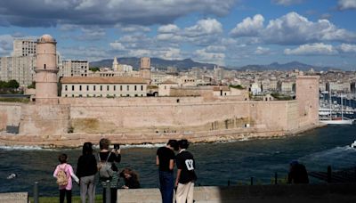 The Olympic torch is being welcomed in French port city of Marseille with fanfare and high security