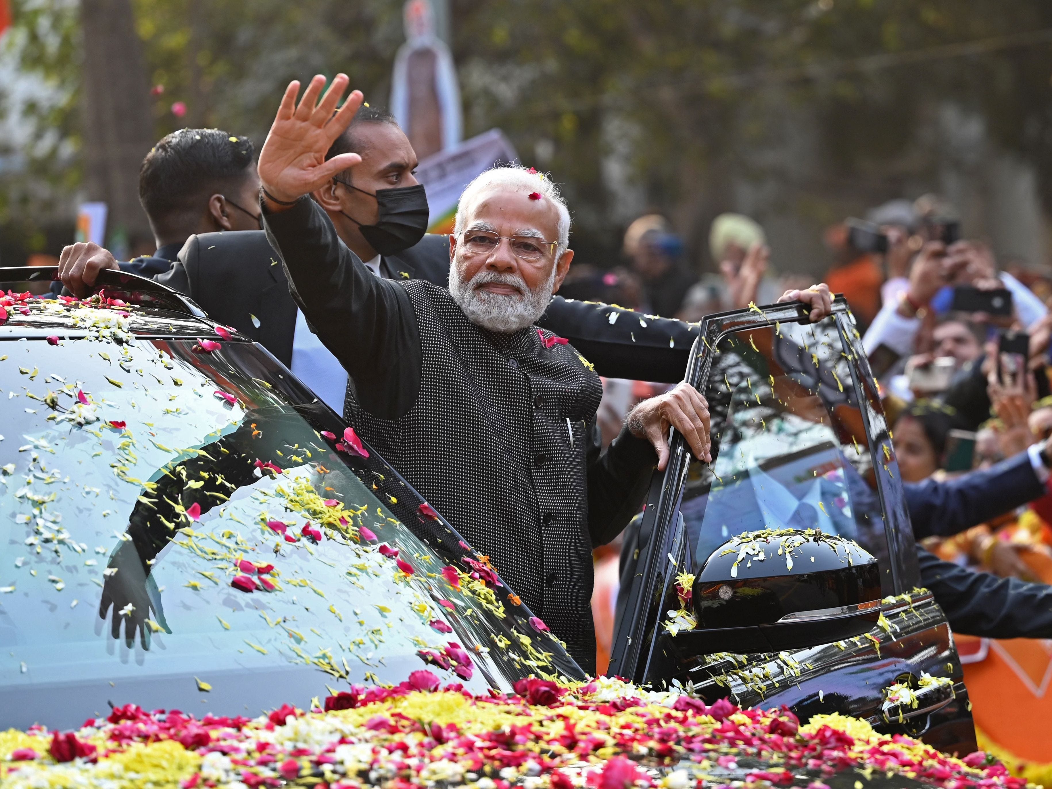 Indian PM Modi steals limelight at lavish Ambani wedding as route to the ceremony lined with posters