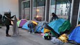 Police clear out a migrant camp in central Paris. Activists say it's a pre-Olympics sweep